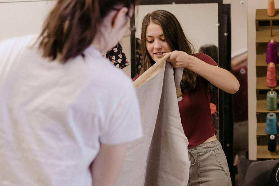 students from the degree in theatre arts making a costume with fabric